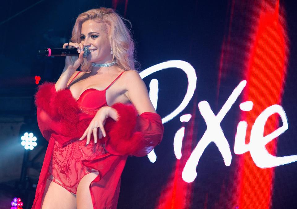  Sizzling Pixie Lott stripped to a busy red corset for a raunchy display at London's G-A-Y