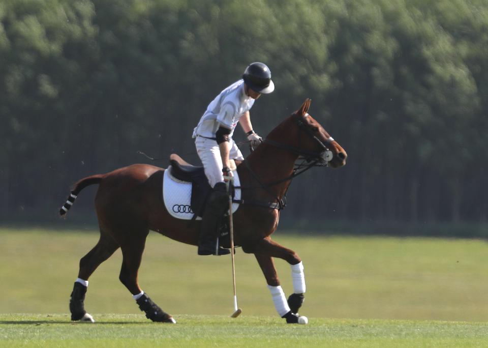  Showing them how it's done ... after his romantic moment with Meg, Prince Harry went for gold at the charity game