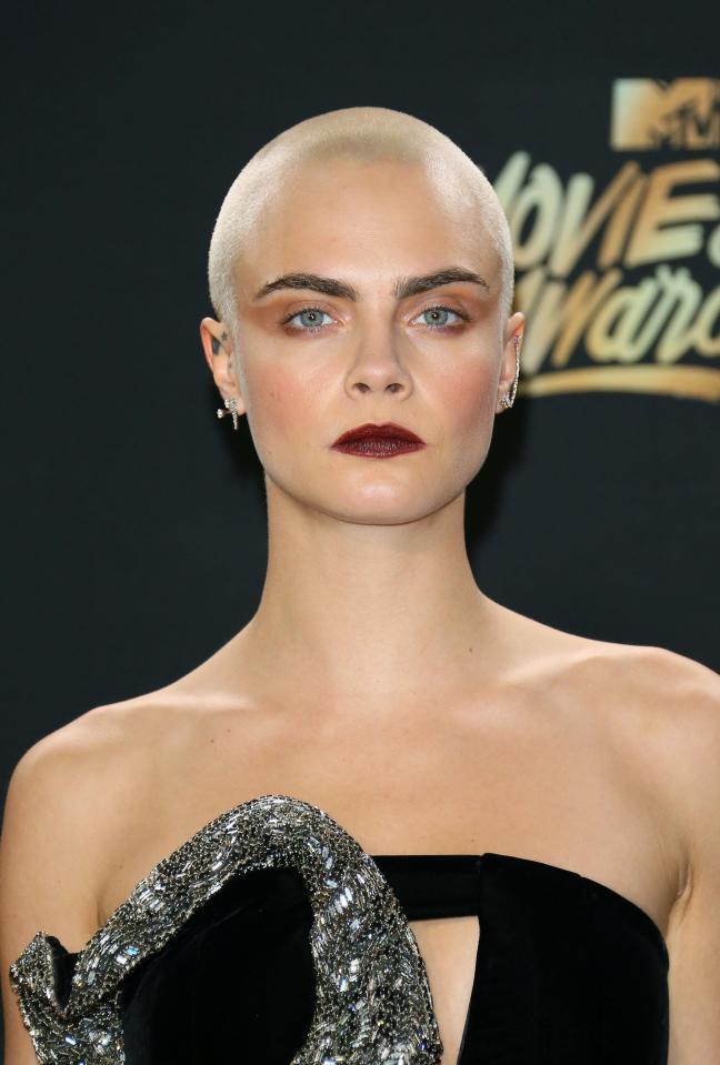  She owned her baldness in a black mini-dress with silver detailing