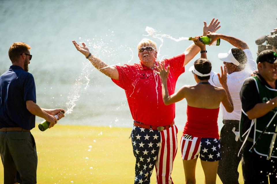  John Daly is sprayed with champagne at the eighteenth green