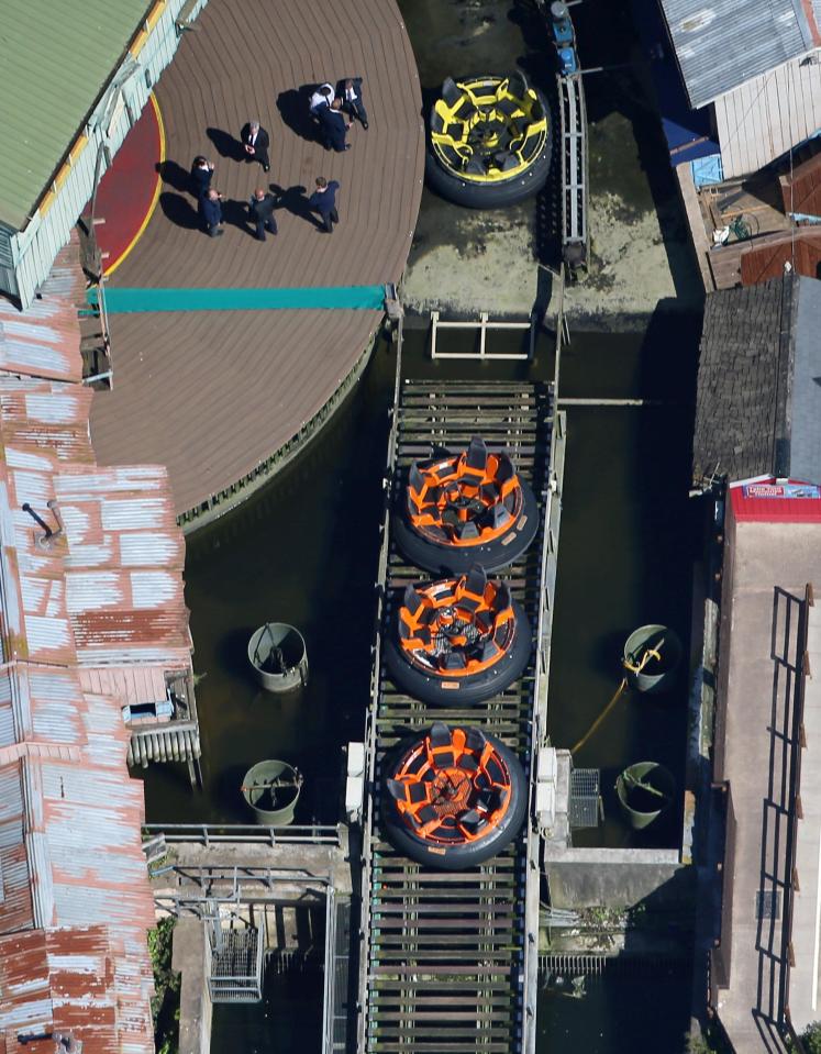  Officials investigate at the site of the closed water rapids ride yesterday