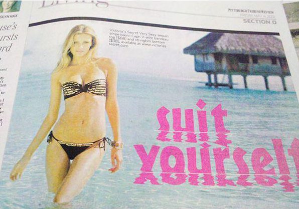 This magazine spread appears to be spelling out a rude word… but its just the unfortunate reflection in the water