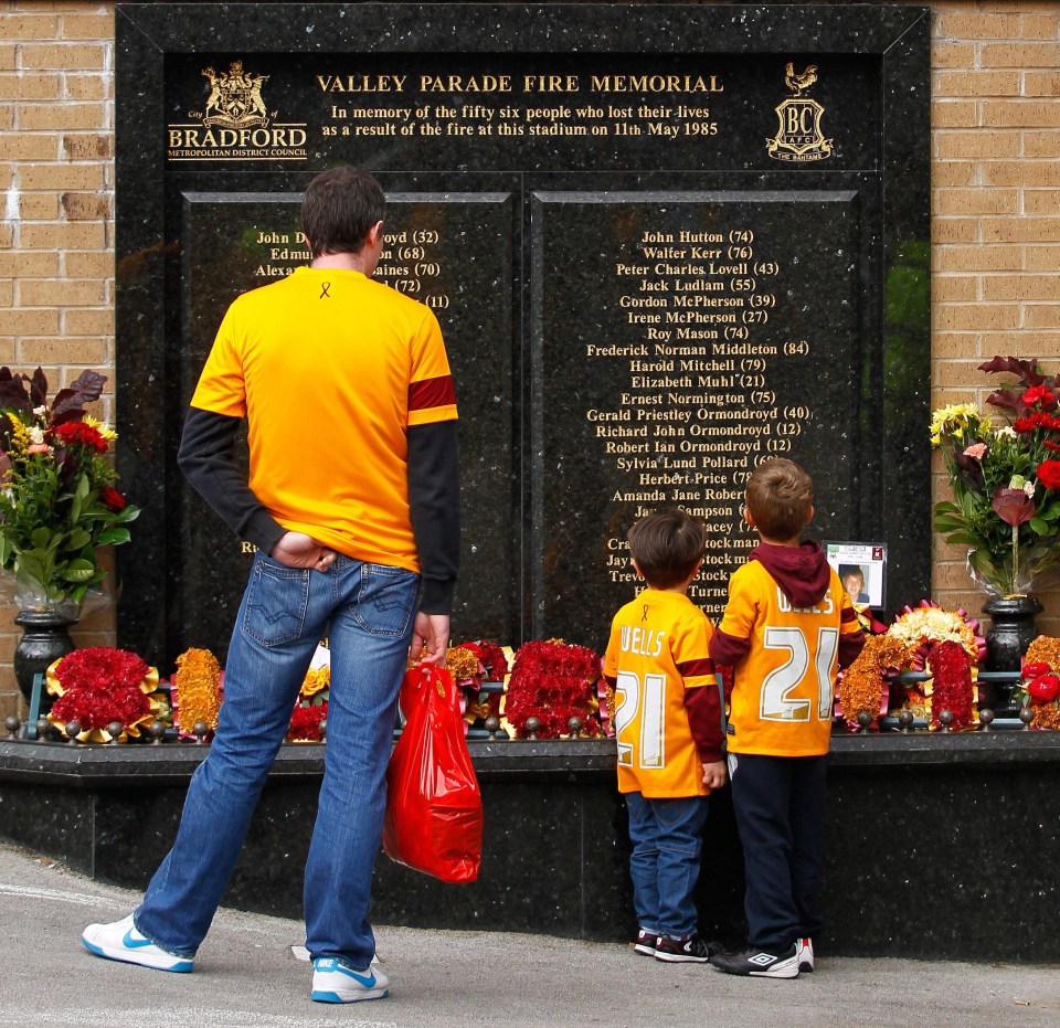 A family take a moment to remember those who lost their lives on that terrible day