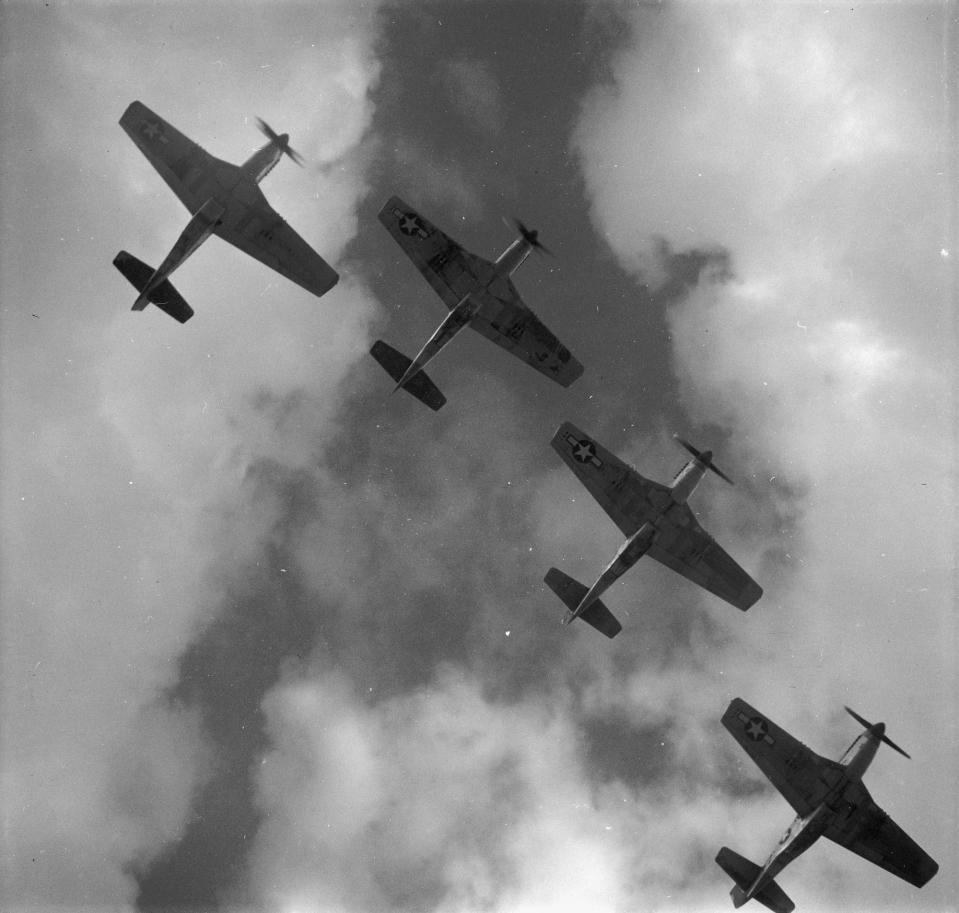  Four P-51 Mustangs flying in formation. They earned the nickname the Red-Tail Angels for their custom crimson-dipped nose and tail paint jobs