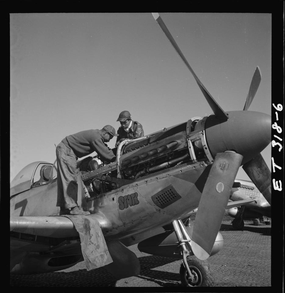  Tuskegee airmen Marcellus G. Smith and Roscoe C. Brown work on an airplane in Ramitelli, Italy, March 1945