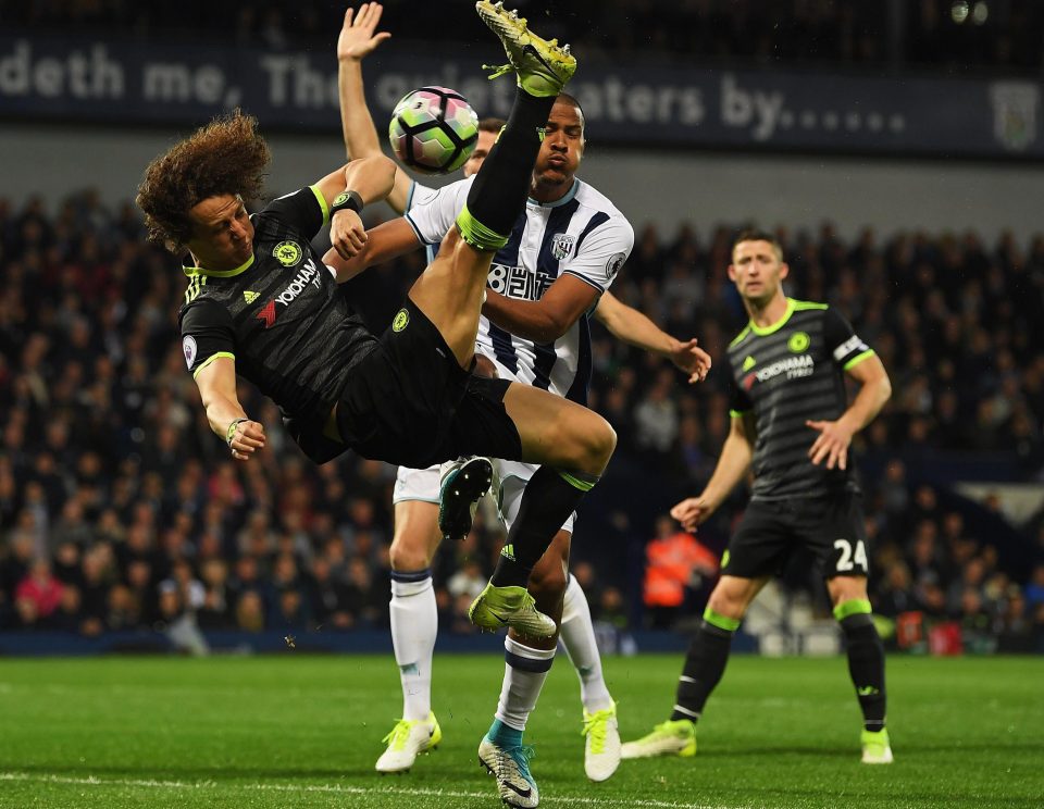  David Luiz goes flying as he challenges for the ball