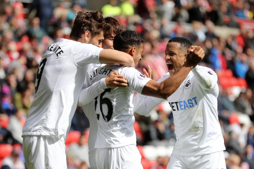  Swansea celebrate as they put the pressure on Hull in the battle to avoid relegation