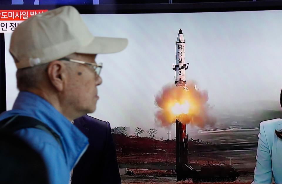  A South Korean man watches a TV broadcast from Seoul reporting on the latest launch