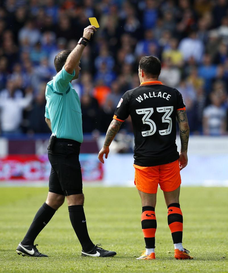  Ross Wallace of Sheffield Wednesday receives a yellow card against Huddersfield Town