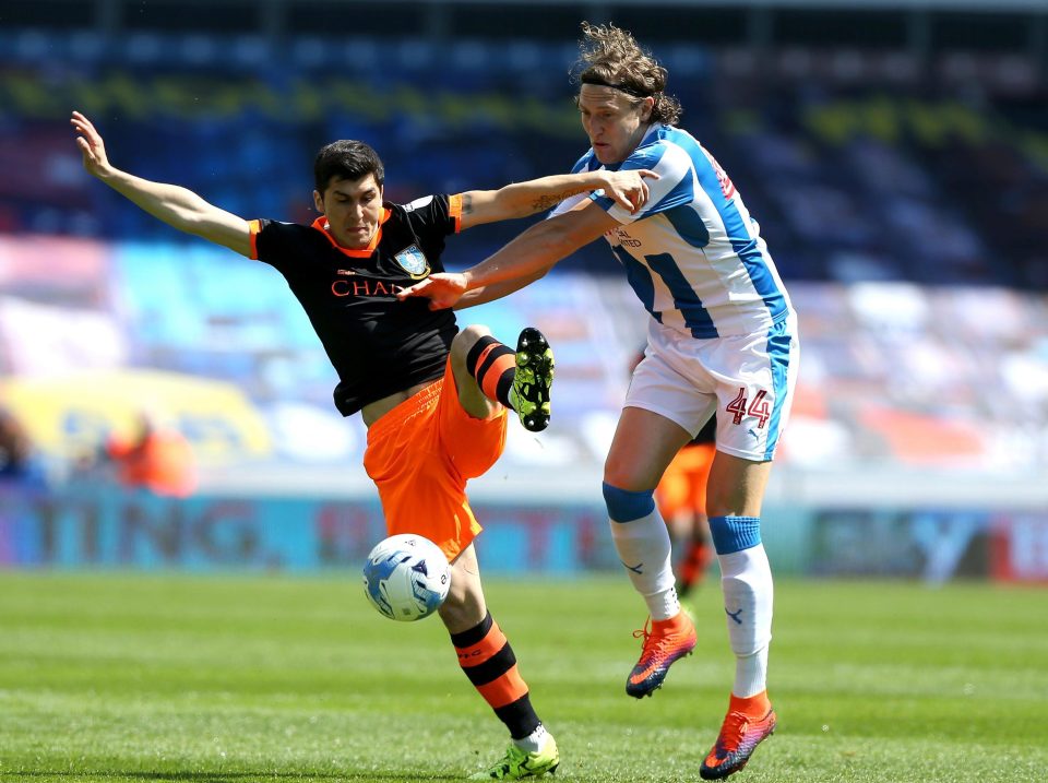  Huddersfield's Michael Hefele and Sheffield Wednesday's Fernando Forestieri tussle for the ball