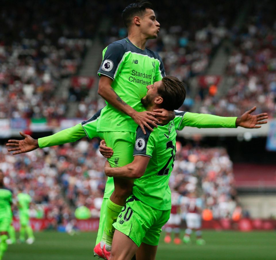  The Liverpool playmaker is hoisted high by Alan Lallana