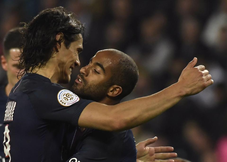  Lucas celebrates with Edinson Cavani after his goal put his side two goals to the good in the 38th minute