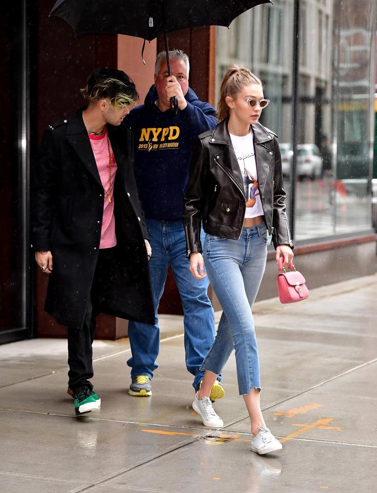  Zayn and Gigi sheltered under an umbrella as the rain hit