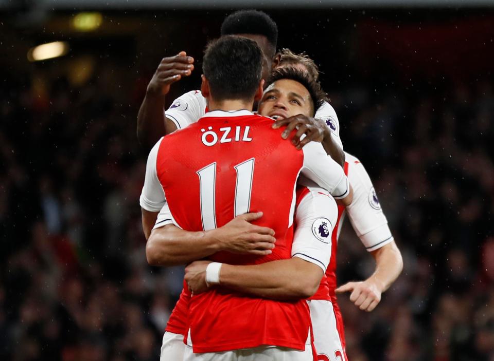  Alexis Sanchez kept Arsenal's top four hopes alive with a late double against Sunderland