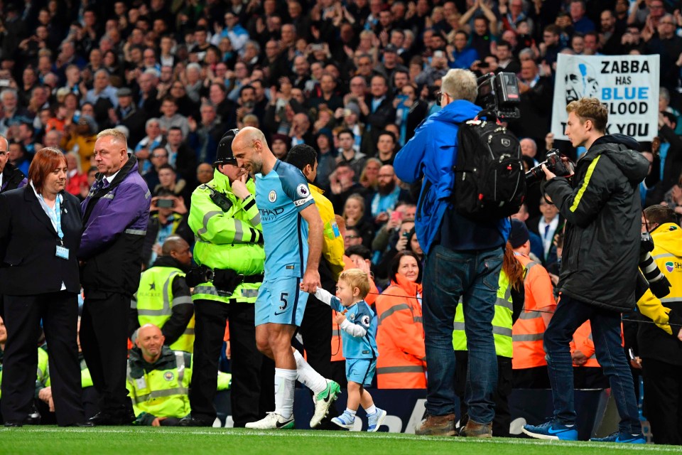 Pablo Zabaleta walks out to a guard of honour with his young child