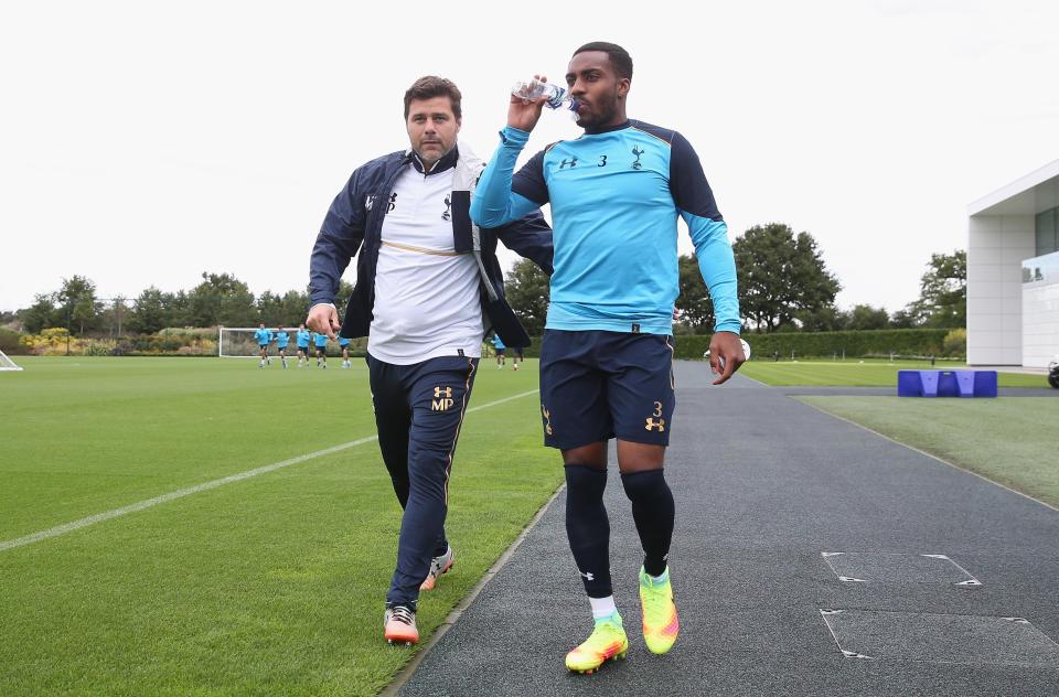  Danny Rose chats to Tottenham manager Mauricio Pochettino during training as he guzzles a bottle of water