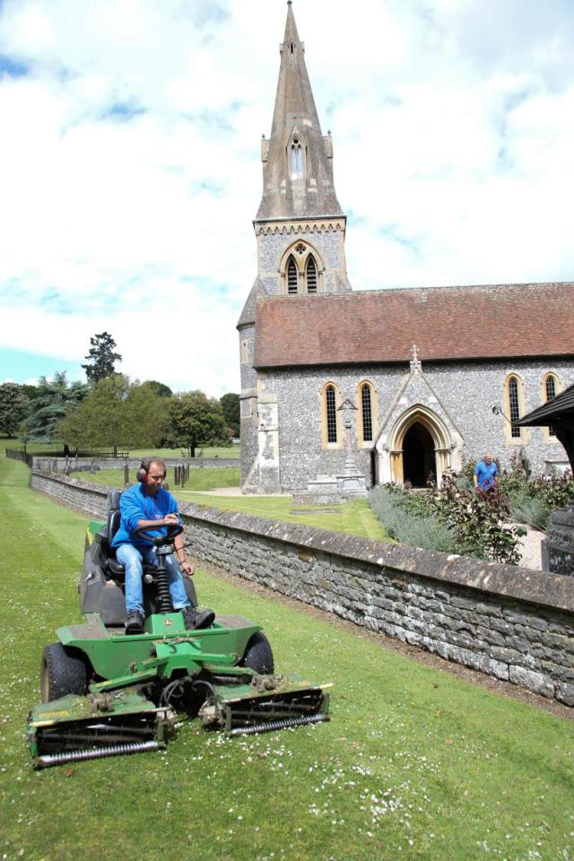  A gardener gives the church grounds a last minute trim