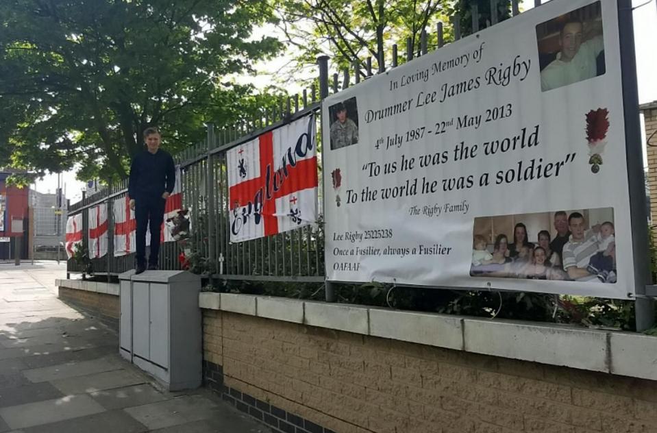  St George's and Union Jack flags along with banners and wreaths with heartfelt messages were tied to railings in tribute to Fusilier Rigby