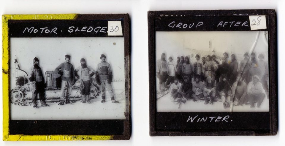  Members of the expedition pose in front of a motor sledge and for a group shot