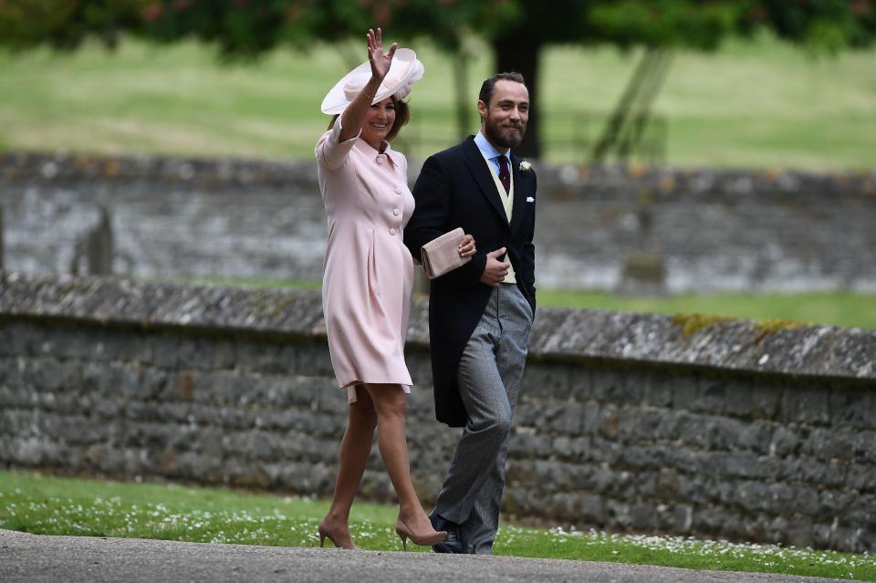  Mother of the bride Carole Middleton waves as she walks towards the church by her son James