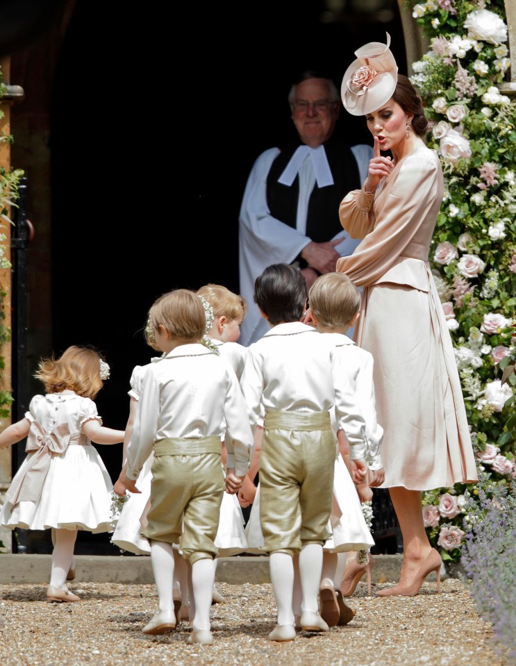 Kate hushes the excitable children as they all bound into the church for the ceremony