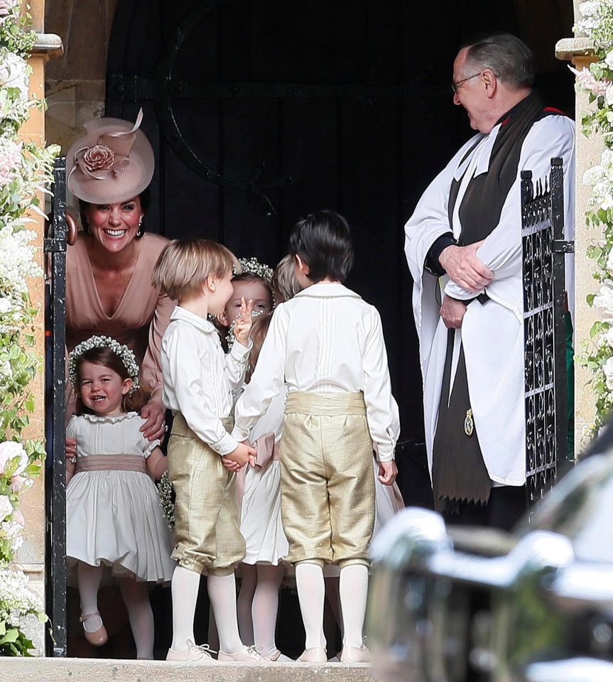  Kate looks the picture of happiness as she watches sister Pippa arrive, while her daughter Charlotte gets ready for bridesmaid duties