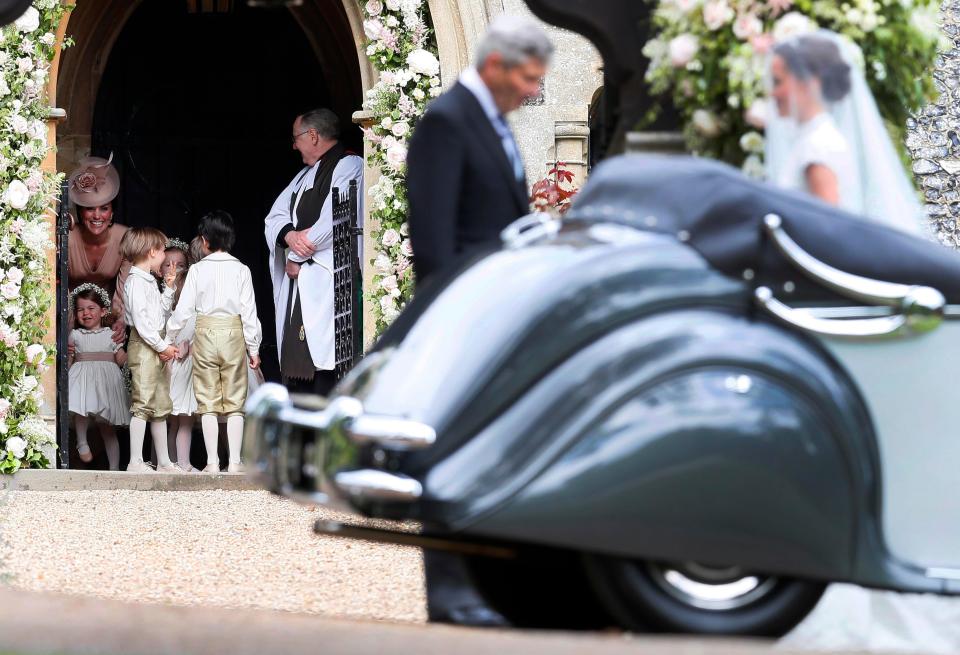  Kate and her children watch on as Pippa's wedding car pulls up outside St Mark's Church