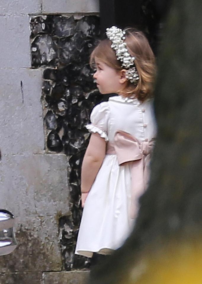  His sister Charlotte wore flowers on her head as she carried out her bridesmaid duties