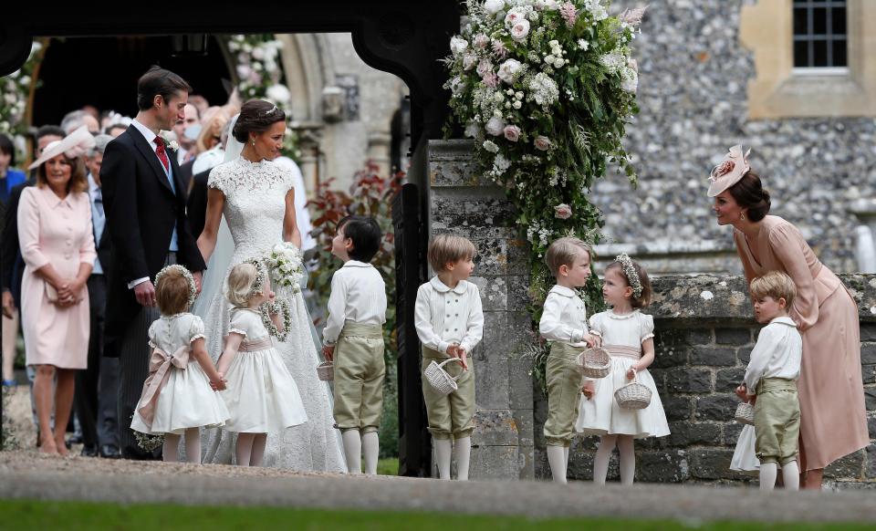  Kate looks over at her newlywed sister as she gathers with page boys and flower girls outside the church