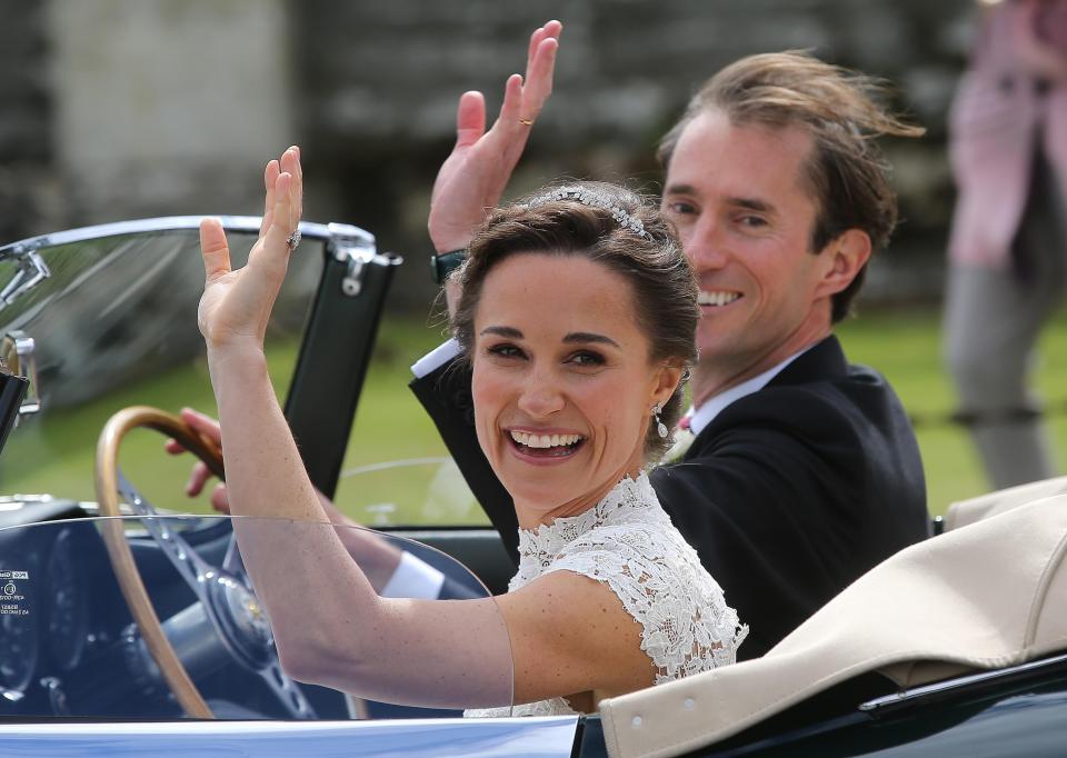  Pippa and James wave to guests as they drive away from their wedding ceremony in Berkshire