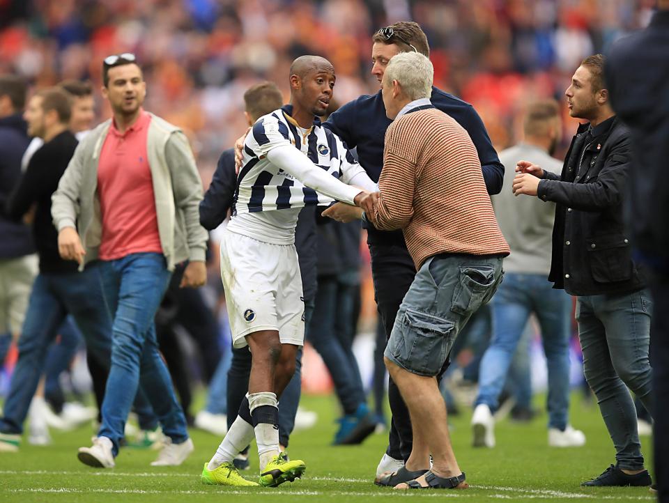  Fans eventually cleared off the pitch quickly, allowing Millwall to lift their trophy