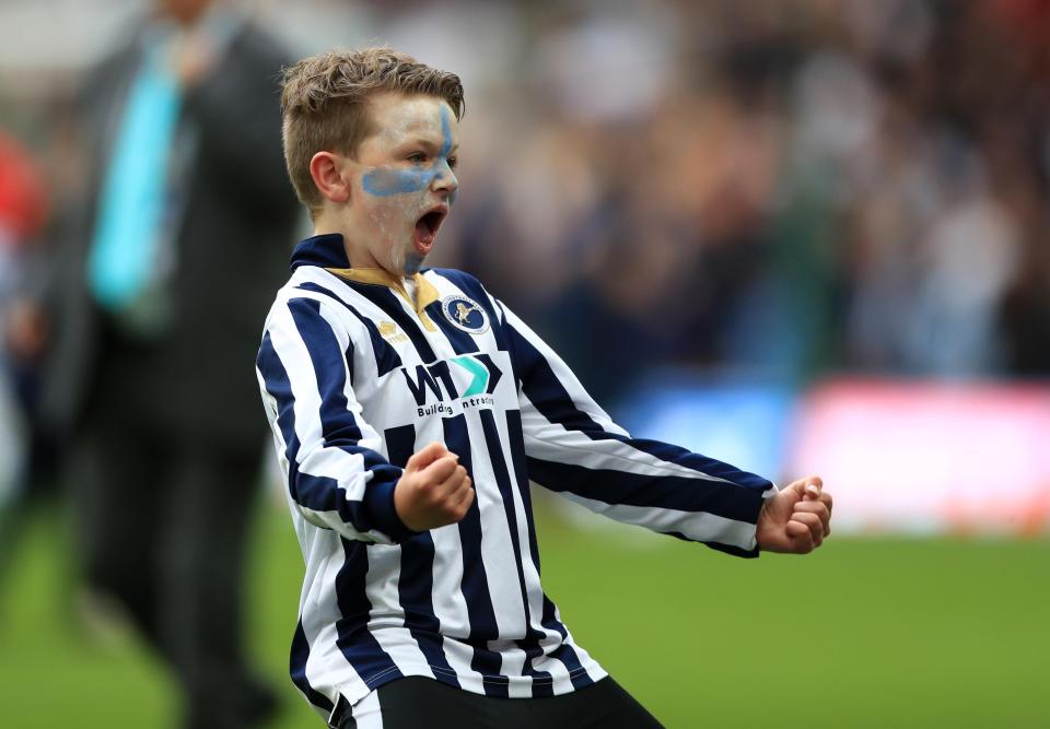  A young fan celebrates on the Wembley pitch