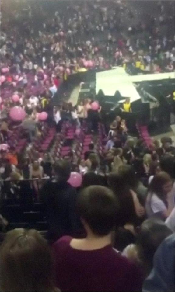  Terrified young fans rush to the exits after hearing the explosion