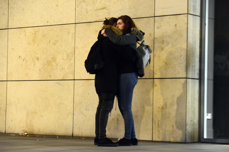  Two friends hug each other near the Manchester Arena after the attack