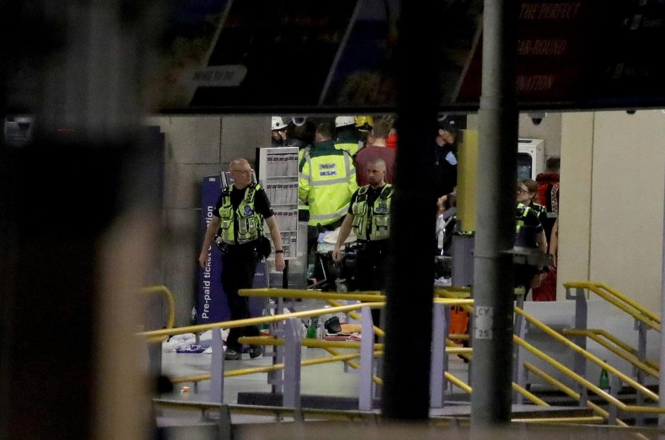  Police and paramedics attend to the carnage in which 22 people were murdered