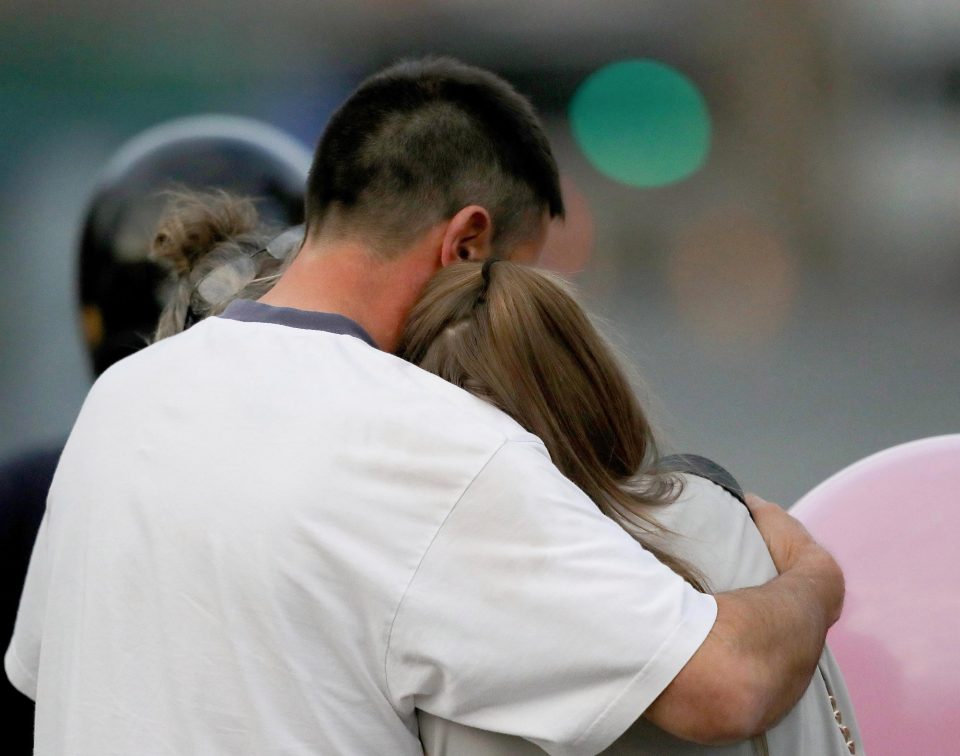  A man embraces a teenager as he collects her from the Park Inn Hotel where they were given refuge after last nights explosion