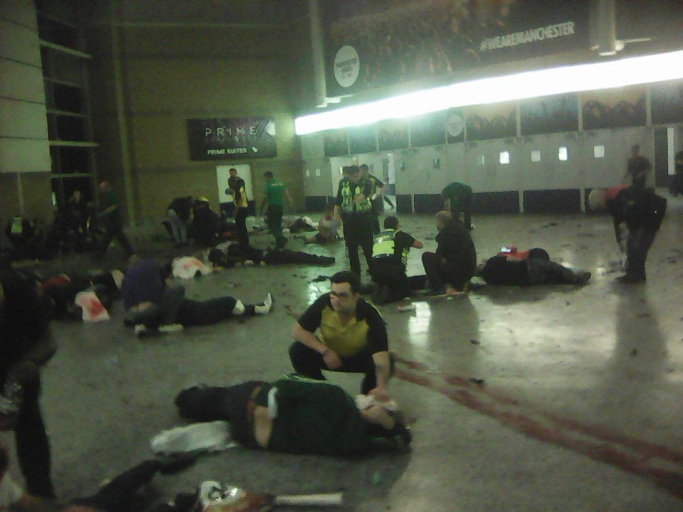 Helpers attend to injured concert-goers inside the Manchester Arena after the bomb attack last night 