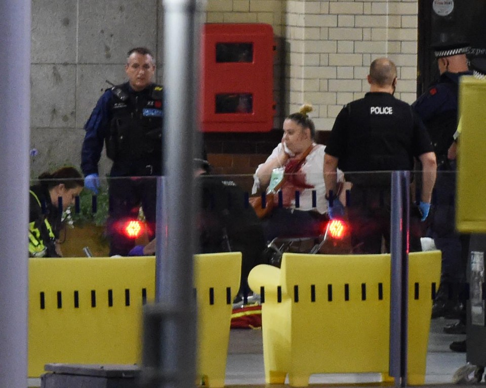 Paramedics attend to a blooded victim outside the arena