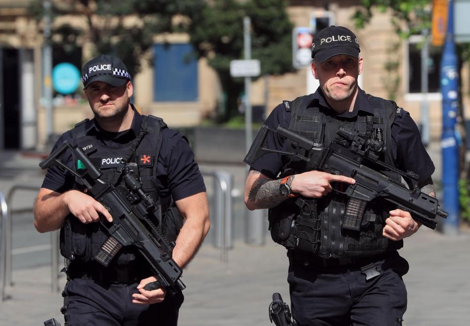  Armed police officers pictured on the streets of Manchester this morning