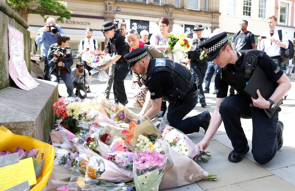  Cops lay floral wreaths at the scene of the massacre