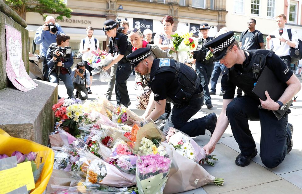  Police lay flowers in Manchester in tribute to victims of the massacre