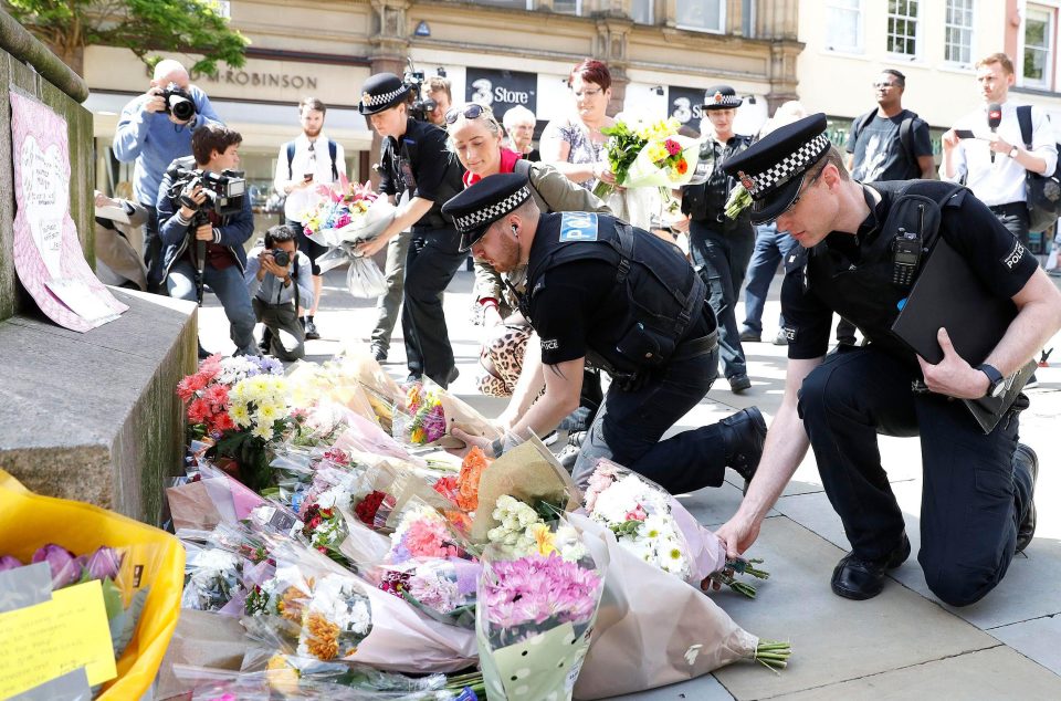  Police lay flowers in tribute to the victims of the Manchester terror attack