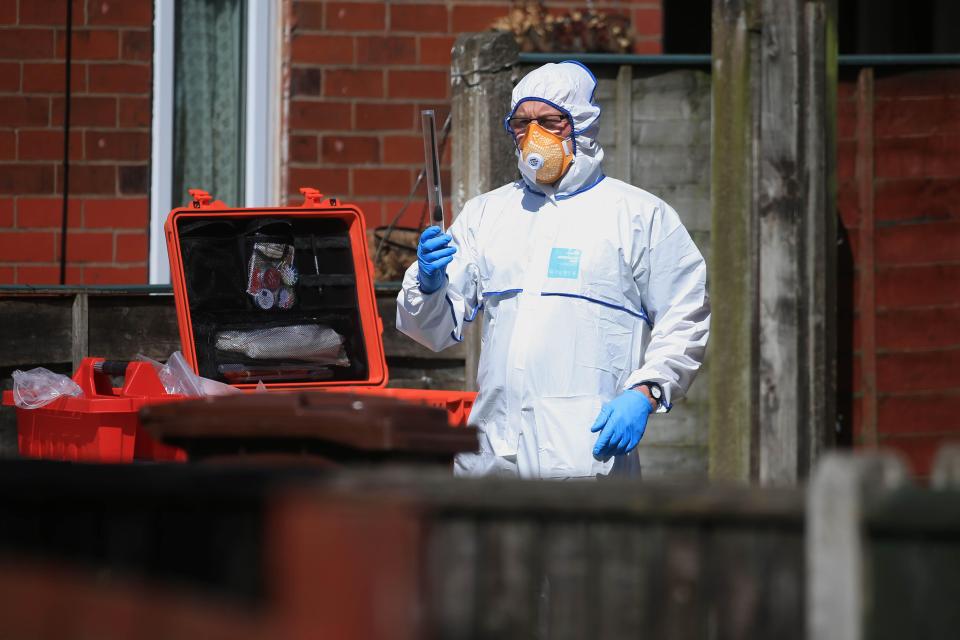  Police forensic investigator works outside the property