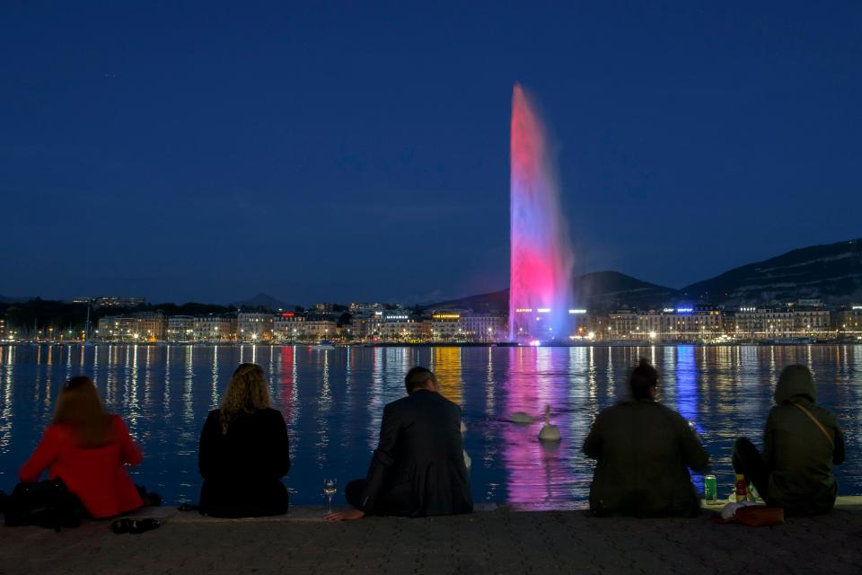  The famous water fountain Le Jet d'Eau in Geneva, Switzerland, is resplendent in the colours of the British flag