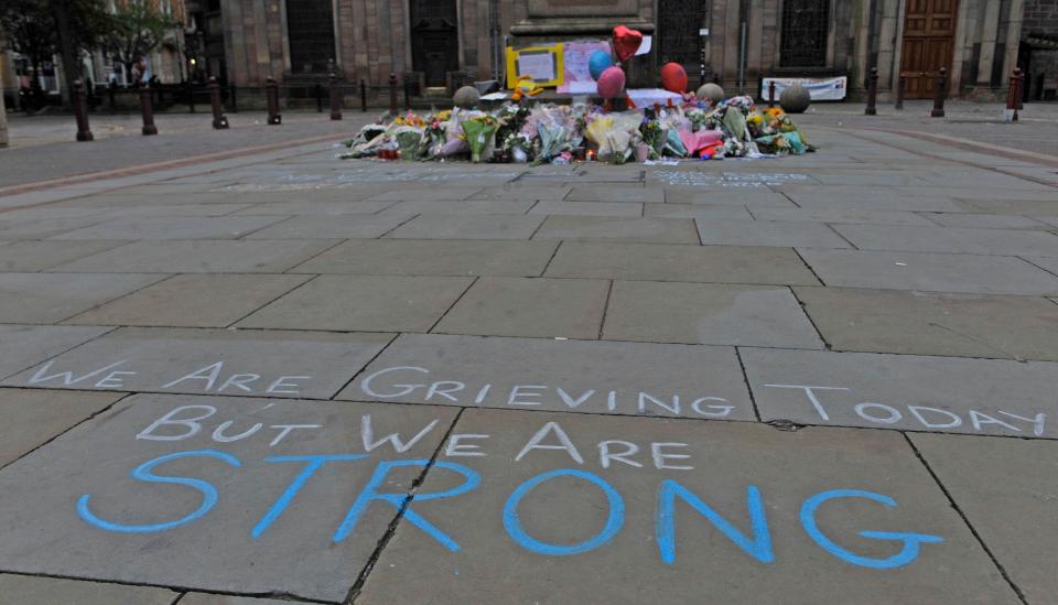  Floral tributes and messages are left in St Ann's Square, Manchester