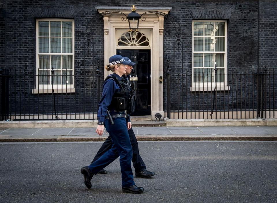  Police officers outside Downing Street after Scotland Yard announced armed troops will be deployed to guard "key locations"