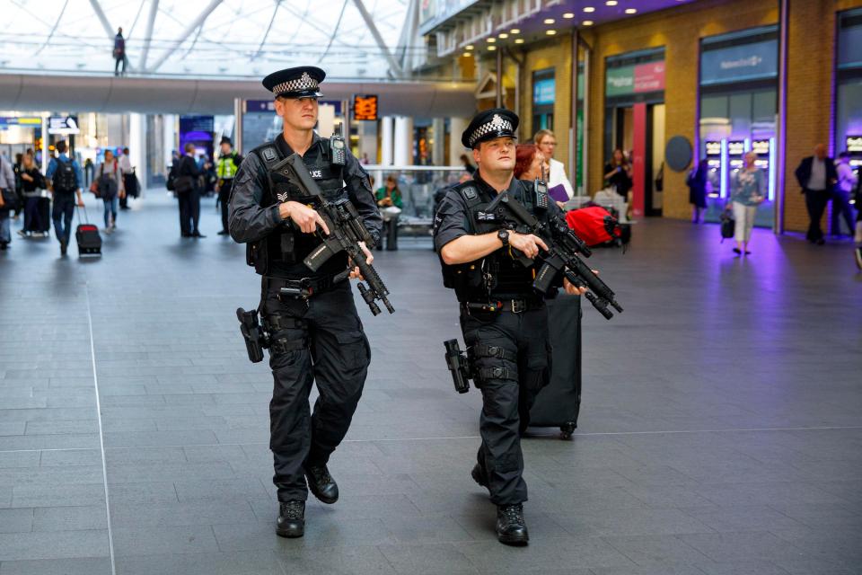  Armed police officers patrol at King's Cross station in London this morning as the terrorism threat level has been raised to critical