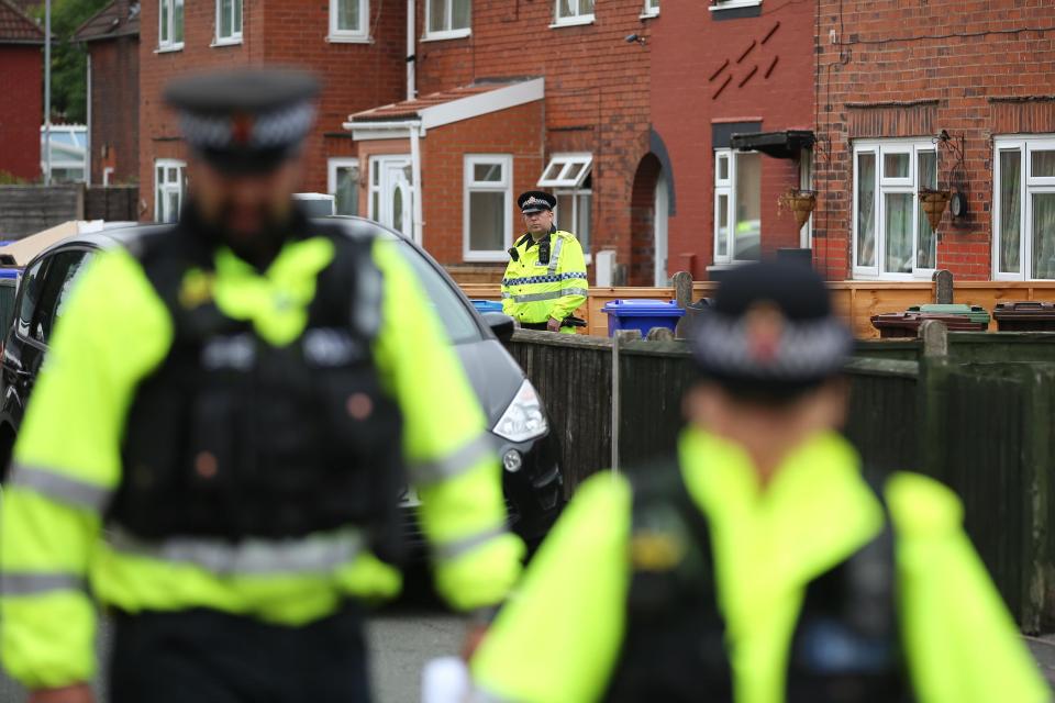  Cops patrol outside the property, as raids and arrests have been made across Manchester and the Midlands