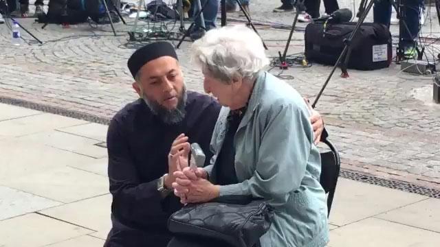  Sadiq Patel and Renee Black were seen comforting each other as they read floral tributes left in Manchester's Albert Square