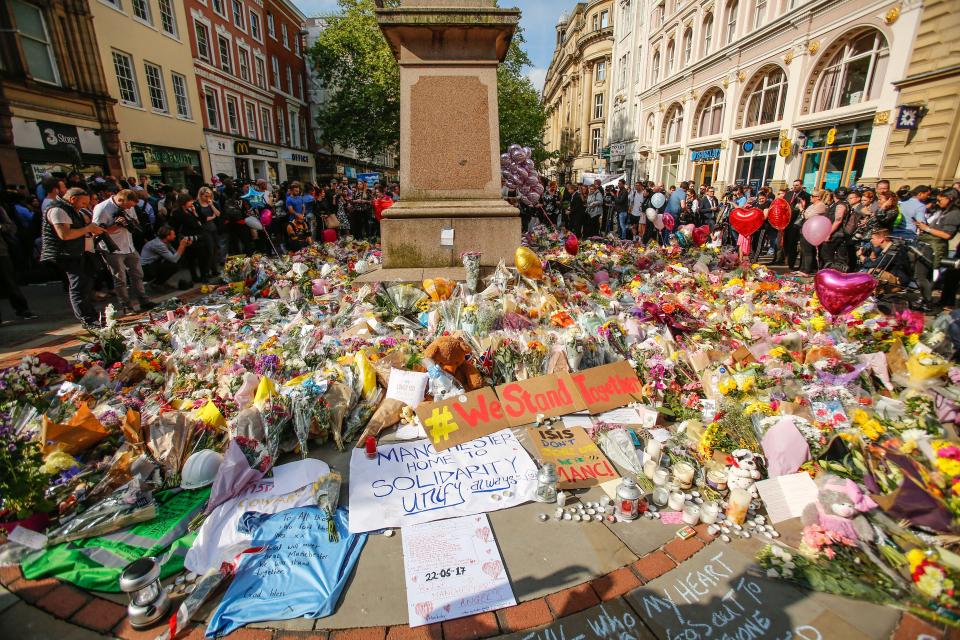  Thousands of people have laid flowers in Manchester to pay tribute to the victims